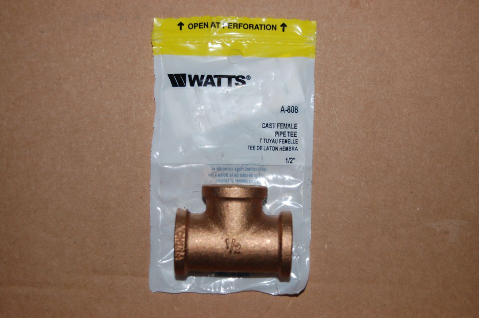 Watts brand 1/2 inch brass pipe tee fitting in packaging