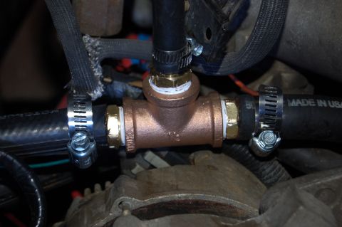 1989 Ford Bronco - A close-up view shows a copper T-fitting installed in a black hose line, secured with hose clamps. The fitting has "CHINA" and "1/2" stampe…