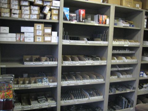 1989 Ford Bronco - Photo of stocked parts shelves in a store, not a technical document.