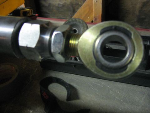 1989 Ford Bronco - A metal rod assembly with visible hardware and a bearing component.