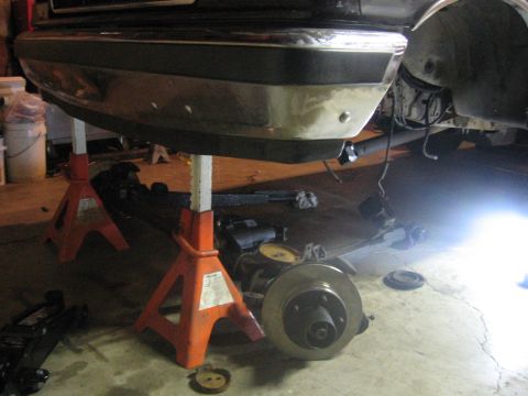 1989 Ford Bronco - Vehicle undergoing maintenance, with rear suspension and brake components exposed.