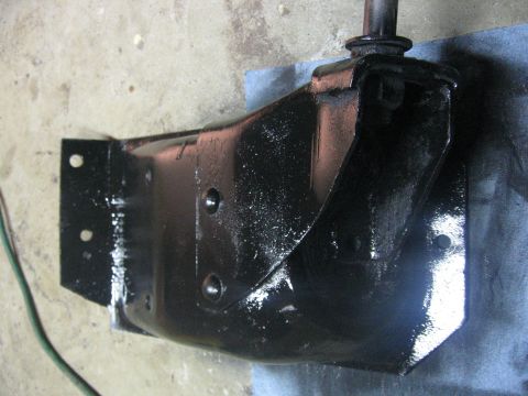 1989 Ford Bronco - A close-up view of a freshly painted metal bracket, likely a vehicle part, resting on a cloth.