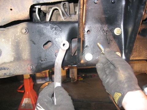 1989 Ford Bronco - Close-up of vehicle frame and suspension components during installation or repair.