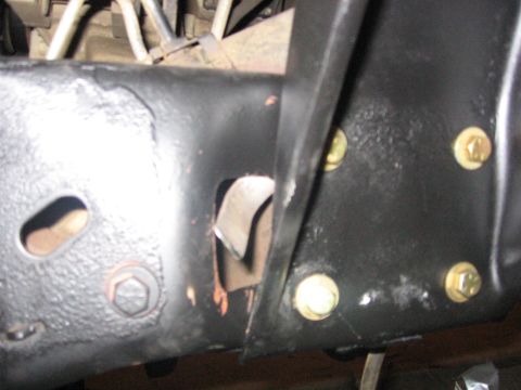 1989 Ford Bronco - A close-up view of a vehicle's frame, showing structural components and fasteners.