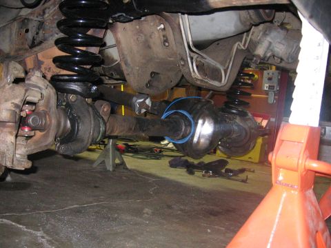 1989 Ford Bronco - Close-up of vehicle undercarriage components, likely during maintenance or repair.
