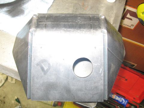 1989 Ford Bronco - A metal component with a circular hole is shown from a top-down perspective.