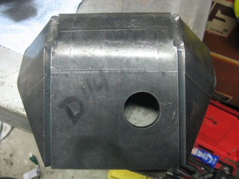 1989 Ford Bronco - A fabricated metal component, possibly a bracket or housing, features a central circular opening and hand-marked identification.