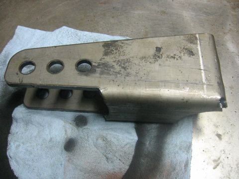 1989 Ford Bronco - A metal bracket with multiple mounting holes is shown on a towel.