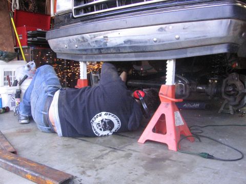 1989 Ford Bronco - Mechanic welding on the undercarriage of a 1989 Ford Bronco.