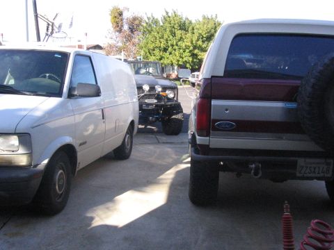 1989 Ford Bronco - A 1989 Ford Bronco is parked in a driveway with a van and another off-road vehicle.