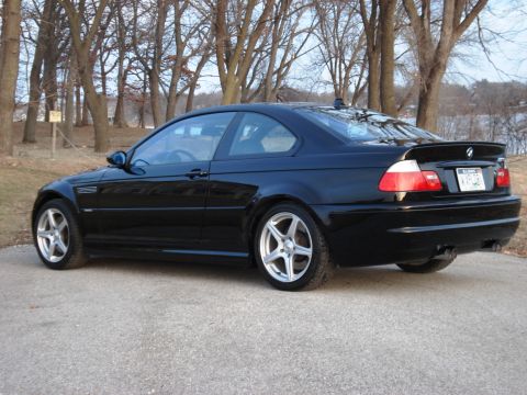 1998 Ford Taurus - Black BMW M3 coupe with distinctive wheels and spoiler.