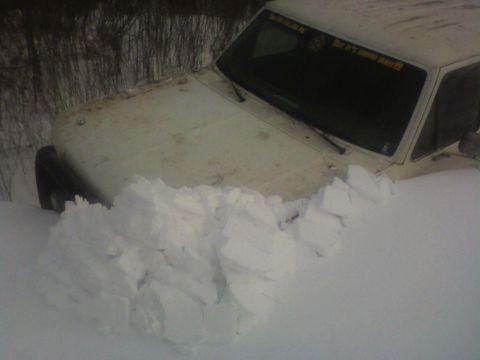 1992 Ford F-350 - Pickup truck stuck deep in snow, only the hood and windshield are visible.