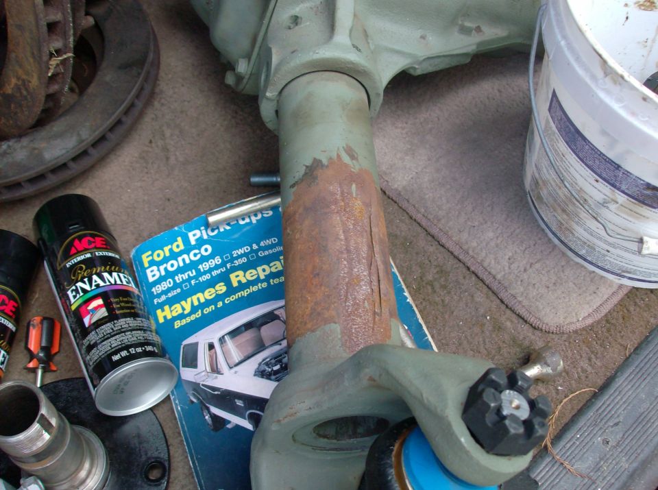 Dana 44 axle part next to Haynes manual for 1980-1996 Ford Bronco