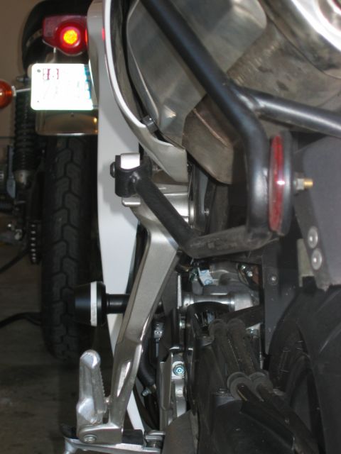 1985 Ford Crown Victoria LTD - The rear section of a motorcycle is visible, with another motorcycle in the background.