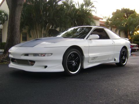 1994 Ford Probe - This 1994 Ford Probe GT features a grey hood and custom black wheels, viewed from the front three-quarter angle.