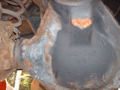 1996 Jeep Grand Cherokee - Close-up of a rusty rear axle differential housing with visible casting marks.