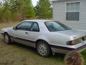 2004 Ford F-150 - A silver 1983 Ford Thunderbird coupe is seen from a three-quarter front angle, parked outdoors.