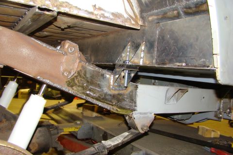 1948 Jeep Wrangler - Close-up view of frame and suspension components during repair work, showing welded metal and new shock absorbers.