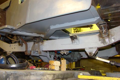 1948 Jeep Wrangler - Undercarriage view of vehicle frame and suspension components, with tools visible.
