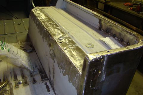 1948 Jeep Wrangler - Metal body panel undergoing repair work, showing welds and unfinished surfaces.