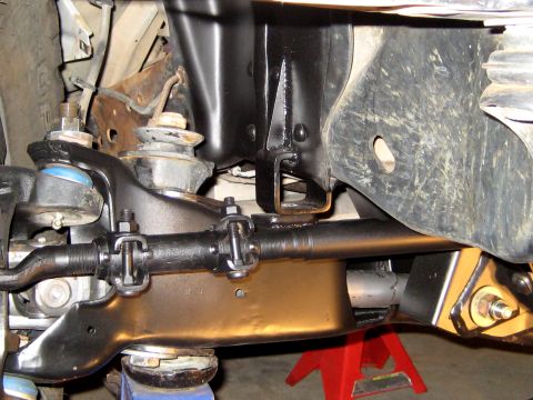 1996 Ford Bronco - Close-up view of the front suspension system, including the tie rod and ball joints.