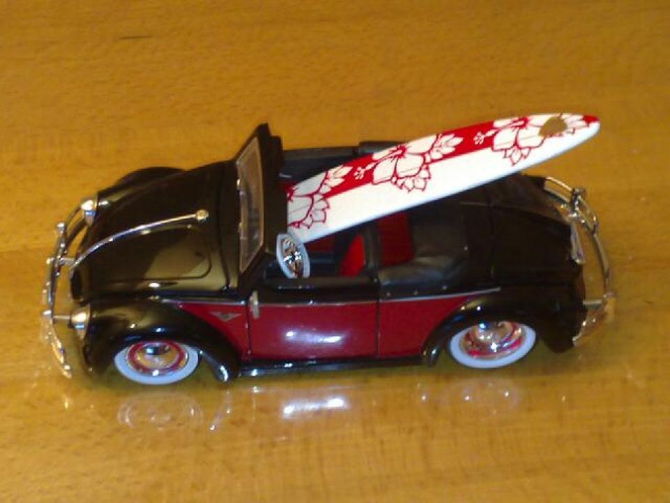 Black and red convertible toy car with surfboard
