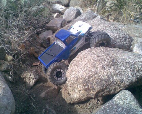 1984 Ford Bronco II - RC crawler truck navigating a challenging rocky obstacle course.