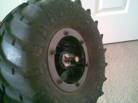 1984 Ford Bronco II - A close-up view of a large, knobby tire and wheel assembly is shown.