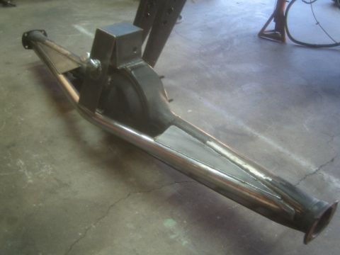 1990 Ford Bronco - Photograph of a welded tubular off-road suspension trailing arm resting on a concrete shop floor.