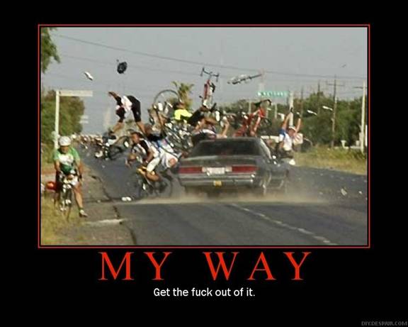 Cyclists and bicycles in a crash on a road with a car driving through.