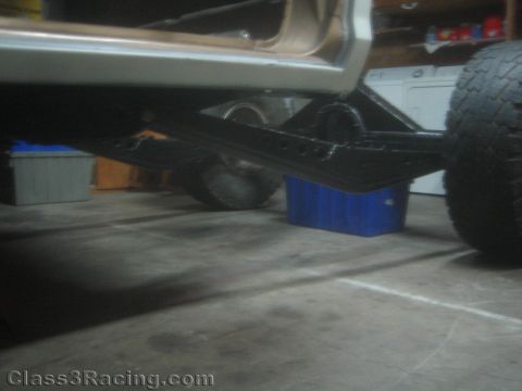 1990 Ford Bronco - Photograph of the underside of a project truck showing fabricated black off-road suspension links.