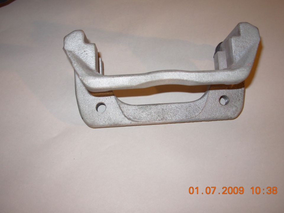 Silver brake caliper bracket on a plain background