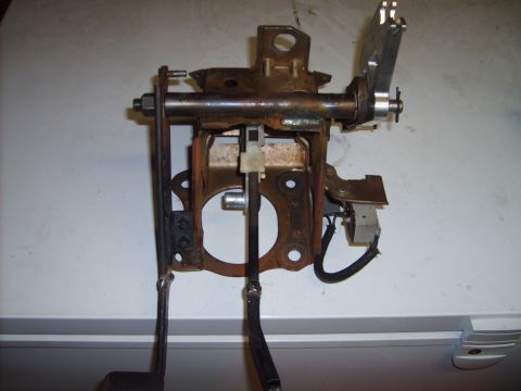1993 Ford Crown Victoria - This is a brake pedal assembly, likely from a vehicle, showing the linkage and a disconnected electrical connector.
