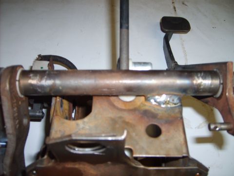 1993 Ford Crown Victoria - Close-up view of a vehicle's clutch pedal assembly, showing the metal rod and pedal pad.