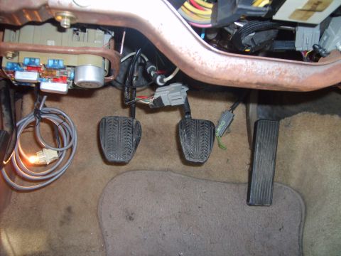1993 Ford Crown Victoria - Interior view of car pedals and fuse box, with visible wiring and connectors.