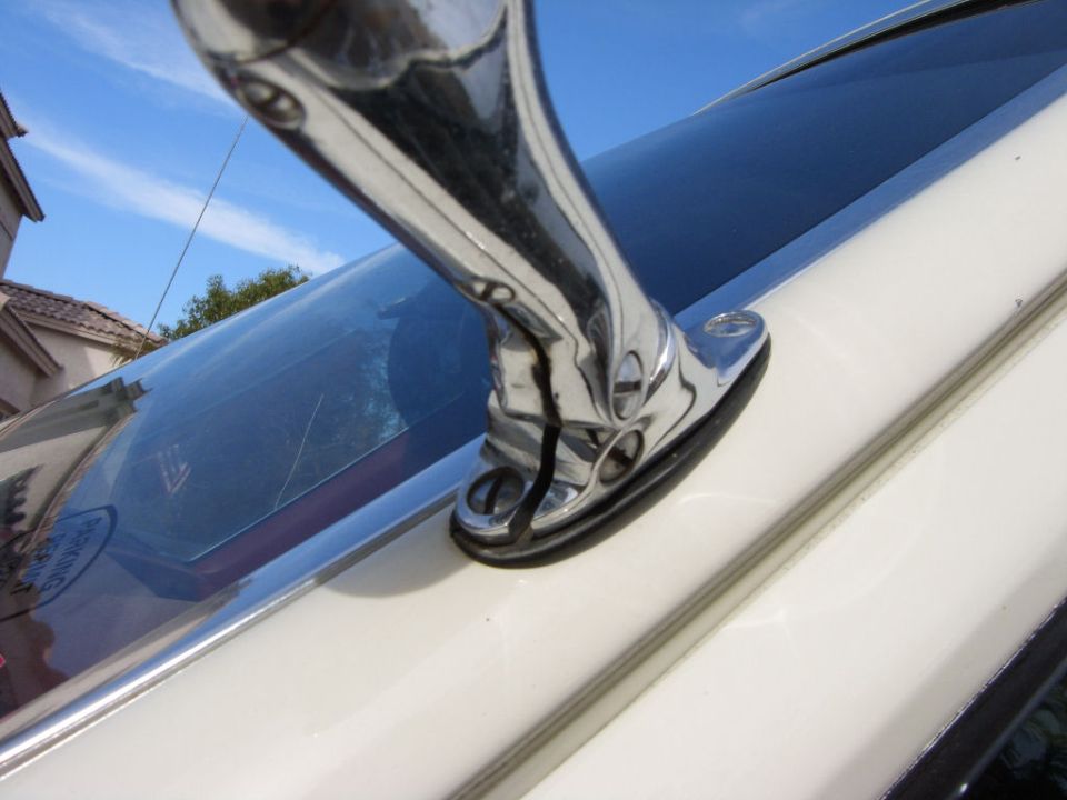 Chrome side mirror on a white vehicle
