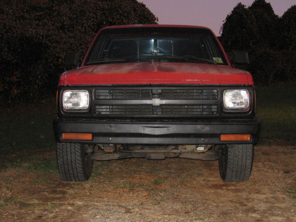 Red pickup truck front view at night