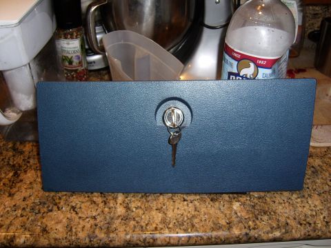 1972 Ford Ranchero - A blue lockable drawer with a key in the lock is shown on a granite countertop. In the background are kitchen appliances and bottles.