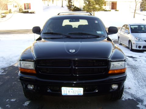 1972 Ford Ranchero - Front view of a black SUV parked on a driveway with snow on the ground. The vehicle has a license plate that reads ELY-8208.