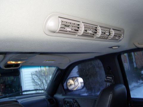 1972 Ford Ranchero - The interior of a vehicle shows a beige overhead air vent with multiple adjustable louvers. Below the vent, a portion of the dashboard and…