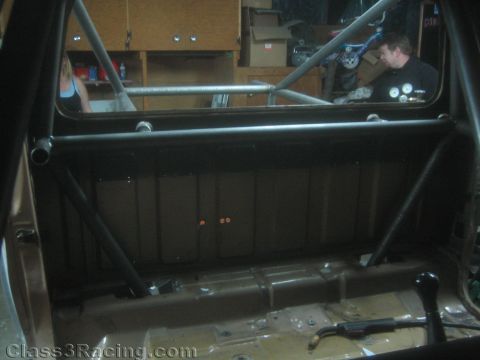 1990 Ford Bronco - Photo looking into a vehicle interior with a welded roll cage during a build, not a technical document.
