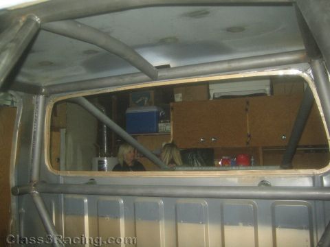 1990 Ford Bronco - Photo of a roll-cage interior and rear window of a project vehicle, not a technical document.
