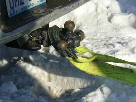 1978 Ford F-150 - A tow hitch assembly and strap are visible against a snowy background.
