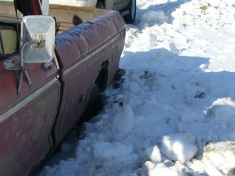 1978 Ford F-150 - This 1978 Ford F-150 is partially buried in snow, with its rear wheel stuck.