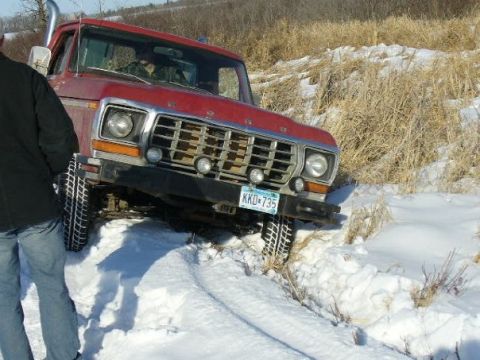1978 Ford F-150 - Red 1978 Ford F-150 truck with snorkel exhaust navigating snowy terrain.