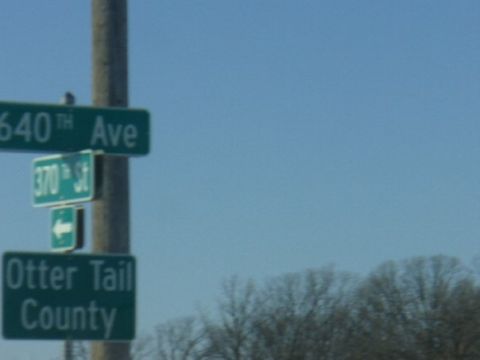 1978 Ford F-150 - Street signs indicate directions for 640th Ave, 370th St, and Otter Tail County under a clear blue sky.
