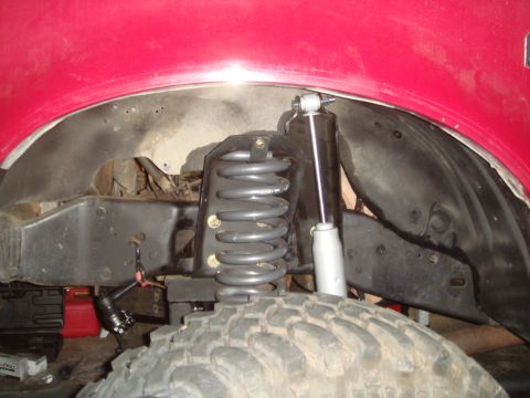 1992 Ford Bronco - Front suspension components of a 1992 Ford Bronco, including the coil spring and shock absorber.