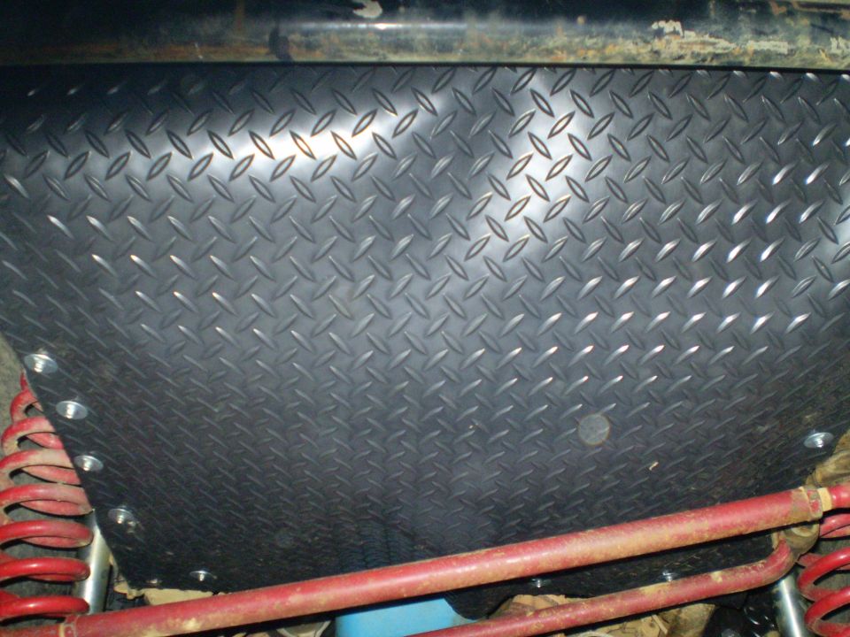 Diamond plate skid plate with red suspension components