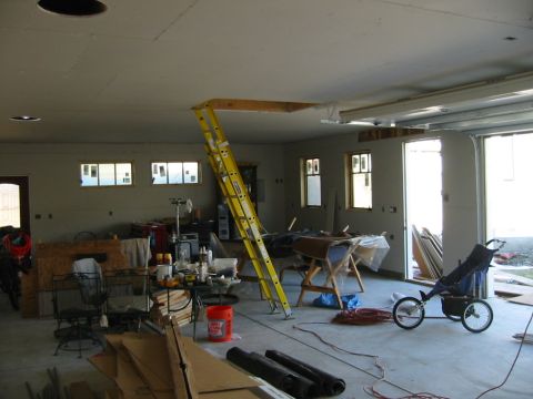 1992 Ford Bronco - Interior view of a garage under construction, showing tools, building supplies, and a stroller.