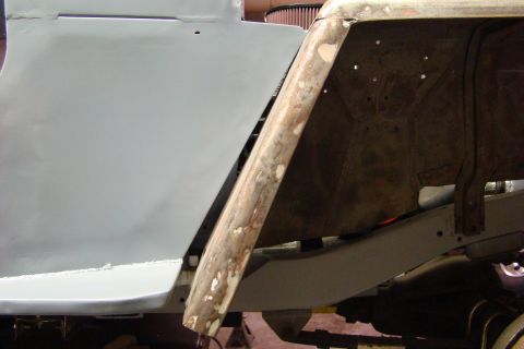 1948 Jeep Wrangler - This photo shows a section of a vehicle's body undergoing repair work, focusing on the metal and primer.